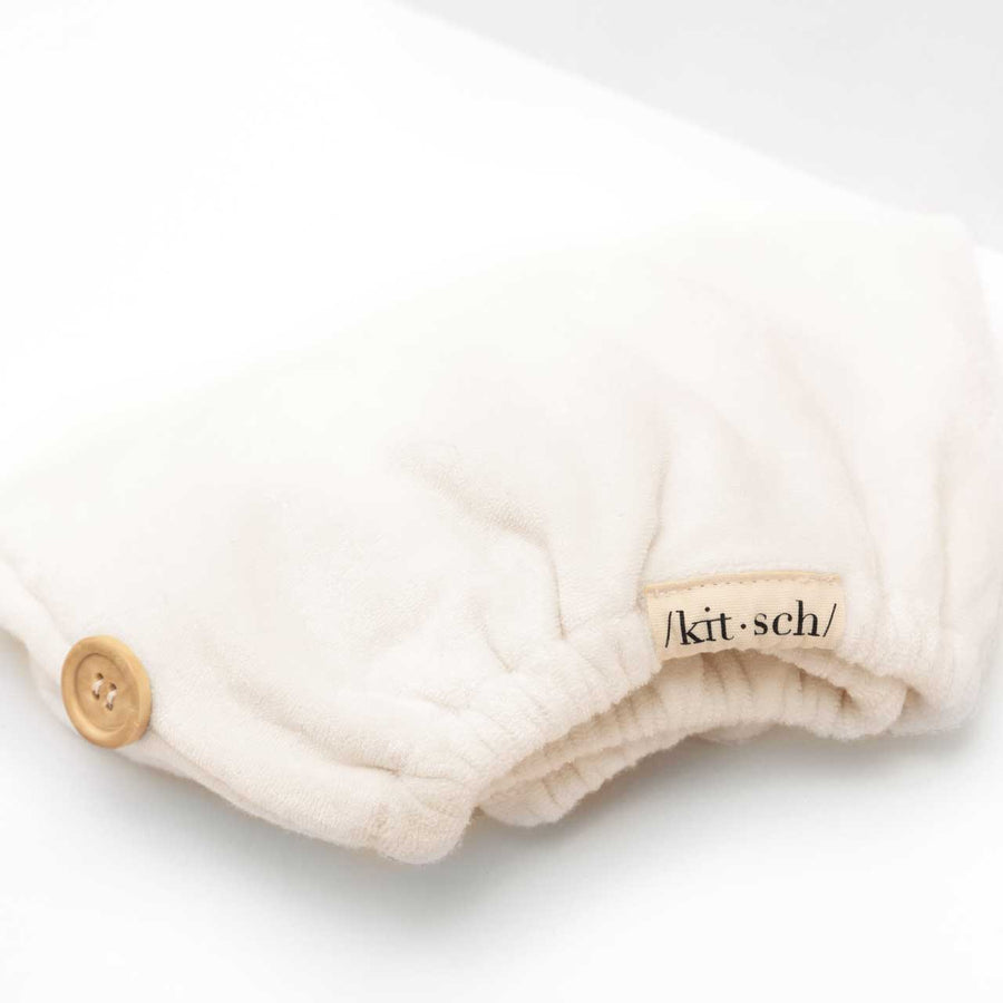 Close-up view of the soft white organic bamboo hair towel fabric highlighting its plush texture.