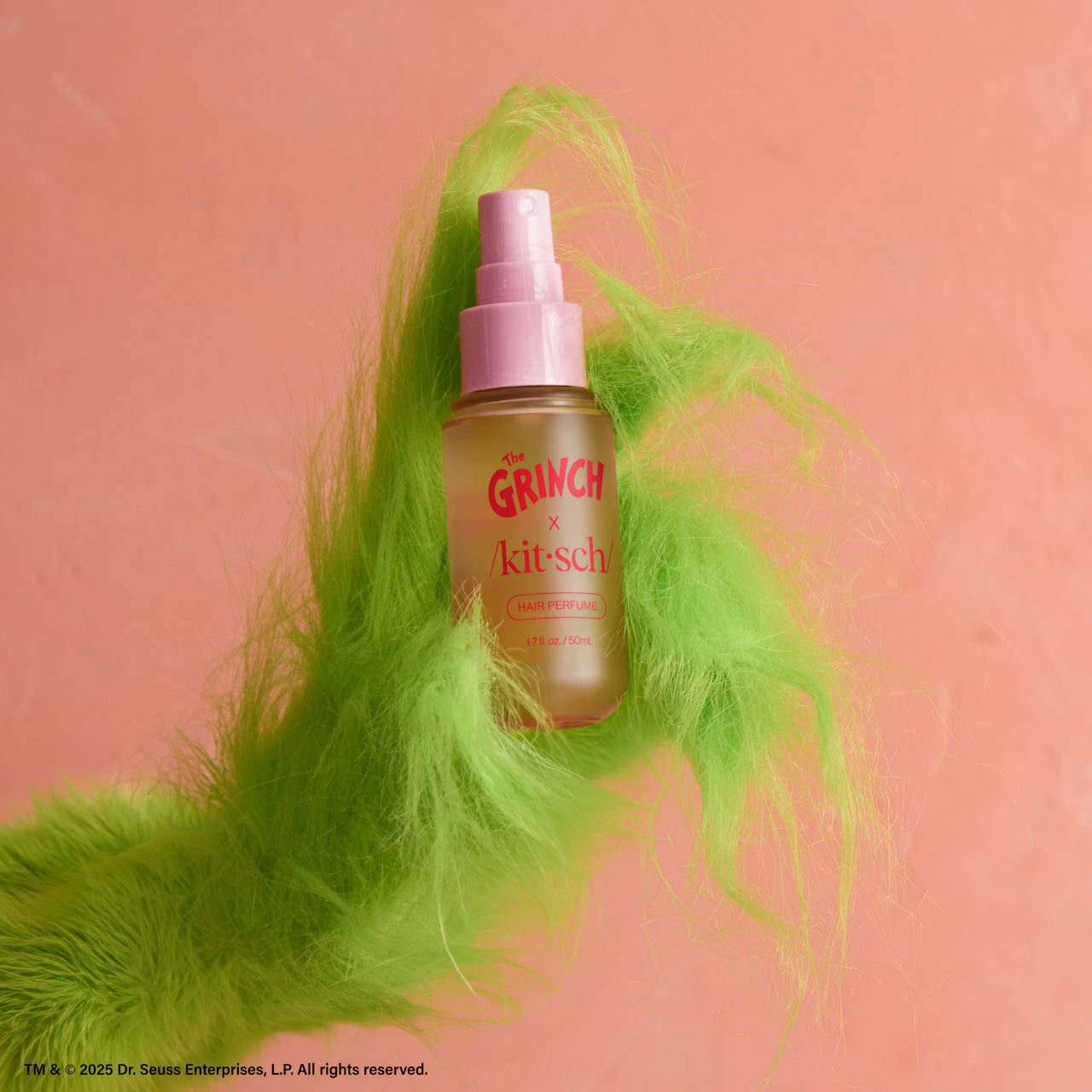 The Grinch x Kitsch Whoville Cookies Hair Perfume bottle styled with holiday accents