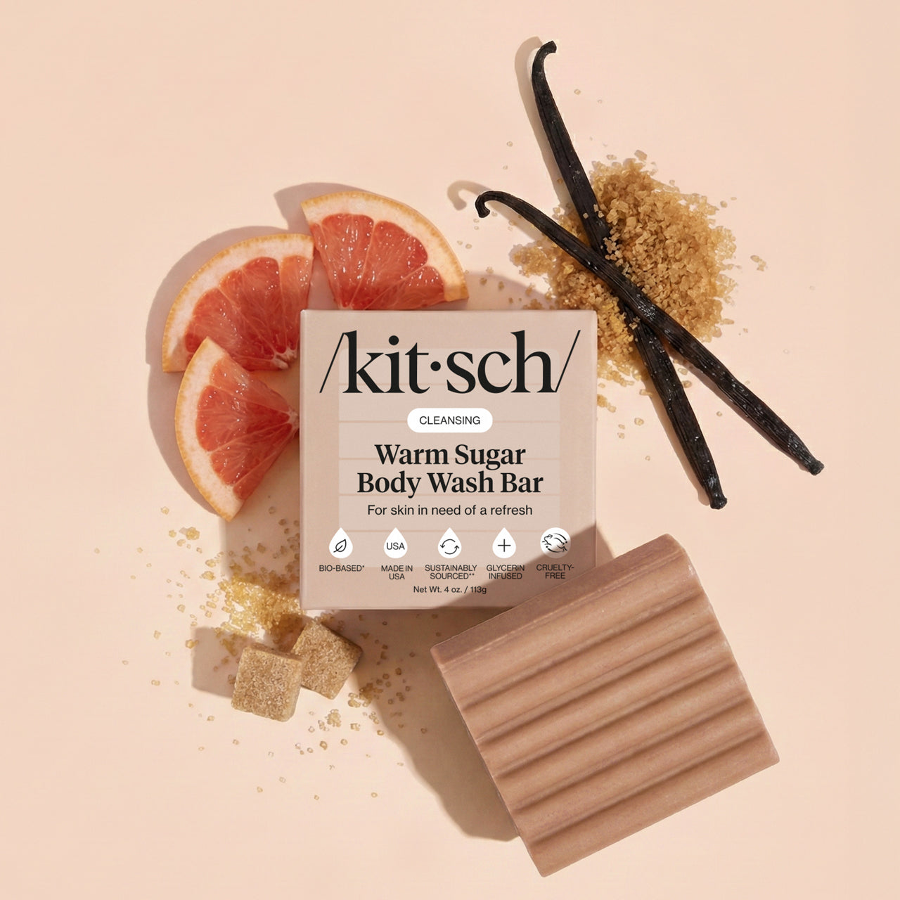 Kitsch Warm Sugar Body Wash Bar with pink grapefruit, vanilla beans, and brown sugar on a beige background