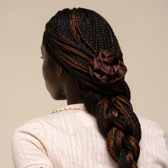 Person with hair styled in a half-up look using the Satin Rosette Medium Flat Cloud Clip in Chocolate