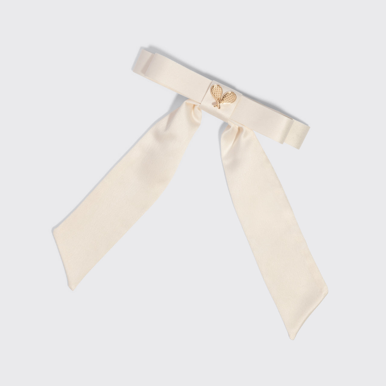 KITSCH Satin Bow Hair Clip - Cream — product shot showing the cream satin bow and gold tennis-racket charm detail — Tennis Core Collection — feminine, playful hair accessory
