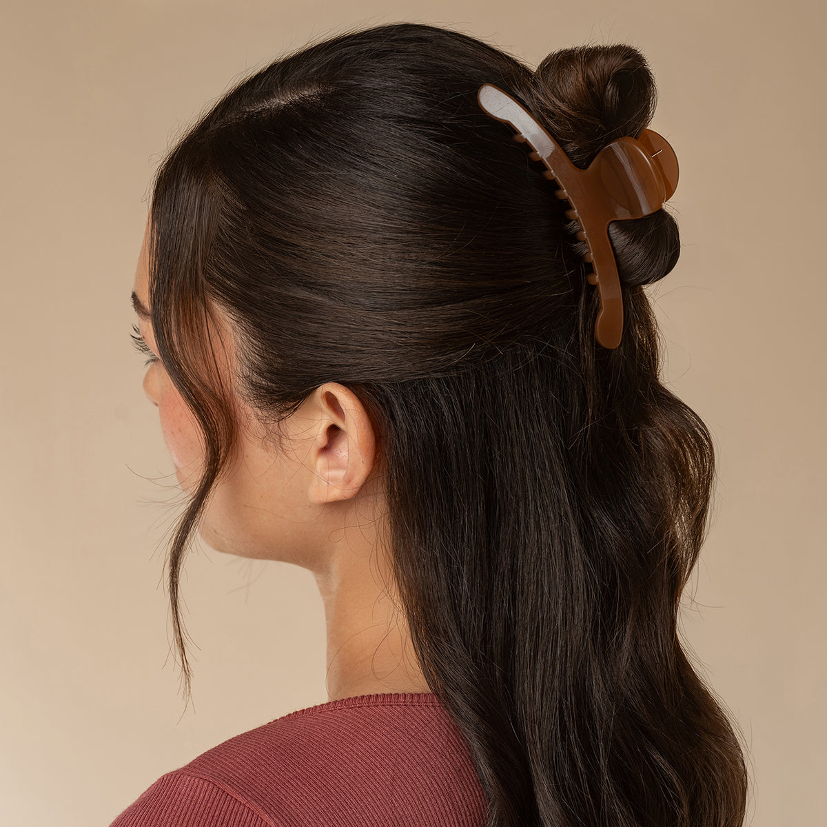 Model wearing translucent Mocha Arched Claw Clip - Large securing dark hair in a half-up hairstyle