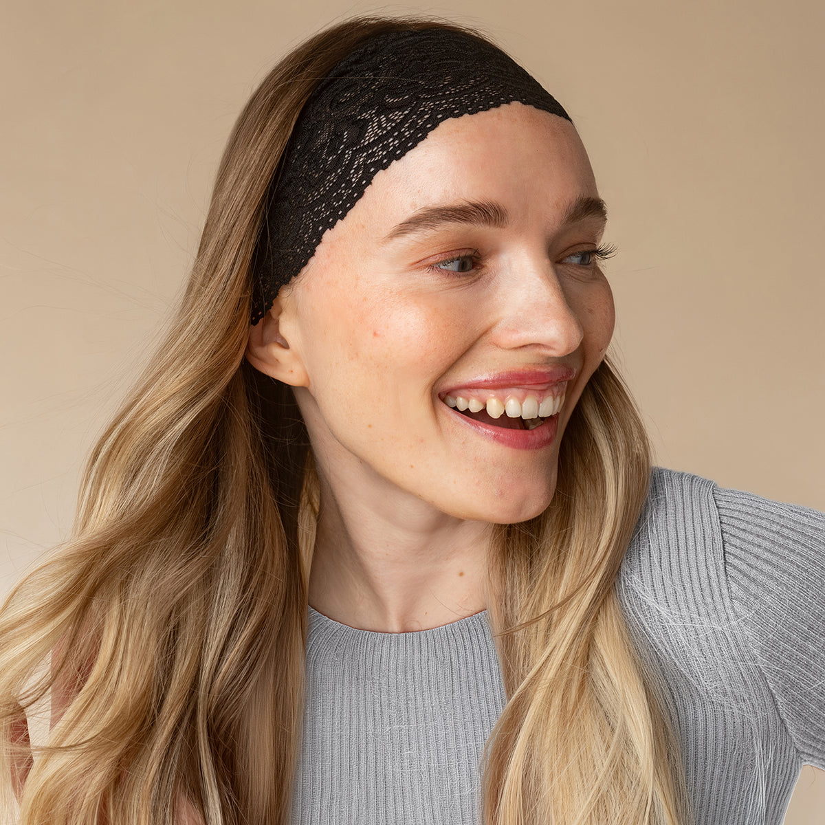 KITSCH Black Wide Lace Headbands 2pc Set — model laughing while wearing the black lace headband in loose hair — no headaches, comfortable and lightweight for all-day wear — all-day wear