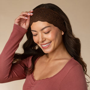 KITSCH Mocha & Chocolate Wide Lace Headbands 2pc Set — model adjusting the chocolate lace headband at her hairline — flexible fit moves with you from day to night — day-to-night styling