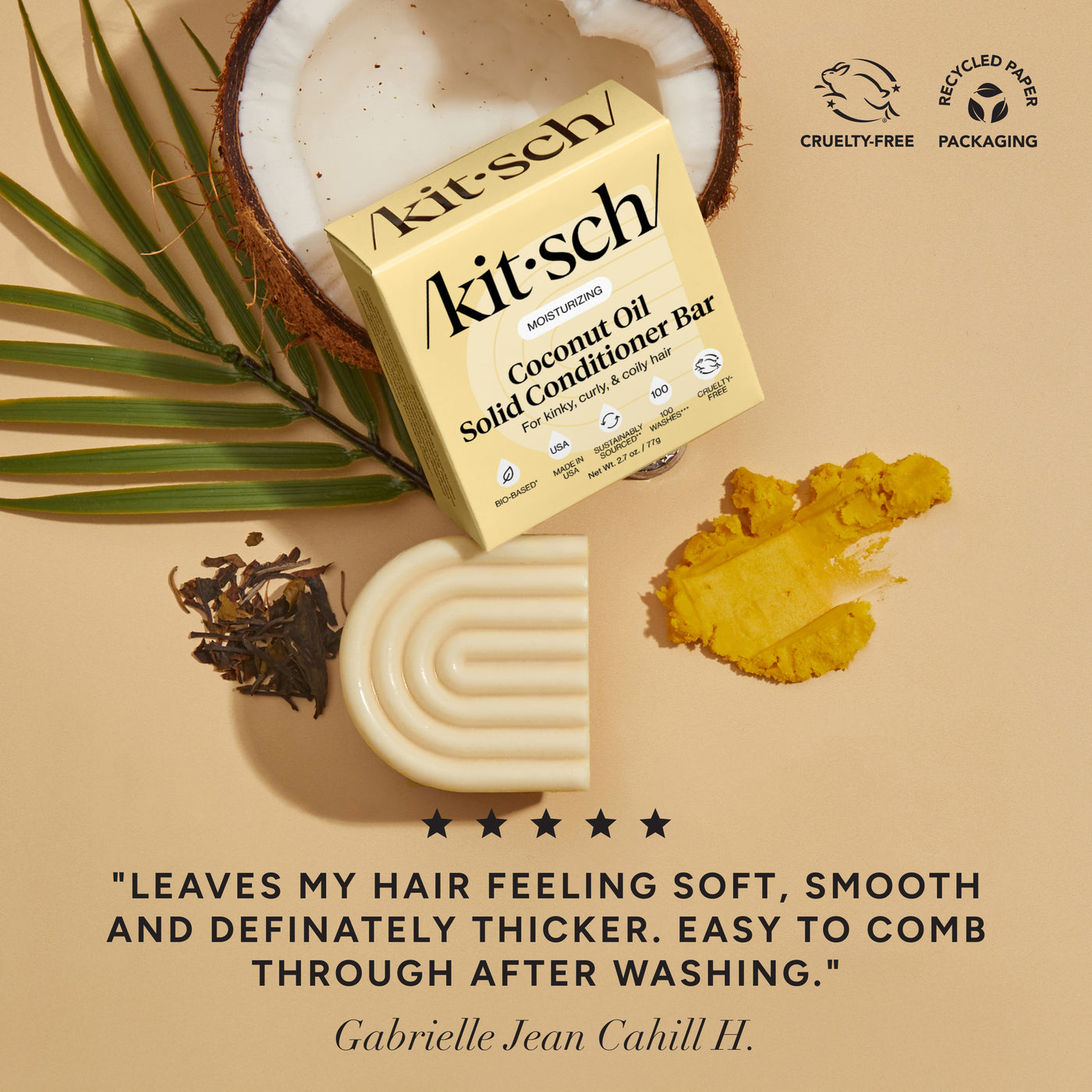 Kitsch coconut oil solid conditioner bar with coconuts & leaves on a beige background. There is a Leaping Bunny Cruelty-free badge and a Recycled paper packaging badge on the top right corner. On the bottom of the image, there is a customer review that says "leaves my hair feeling soft, smooth, and definitely thicker. Easy to comb through after washing"