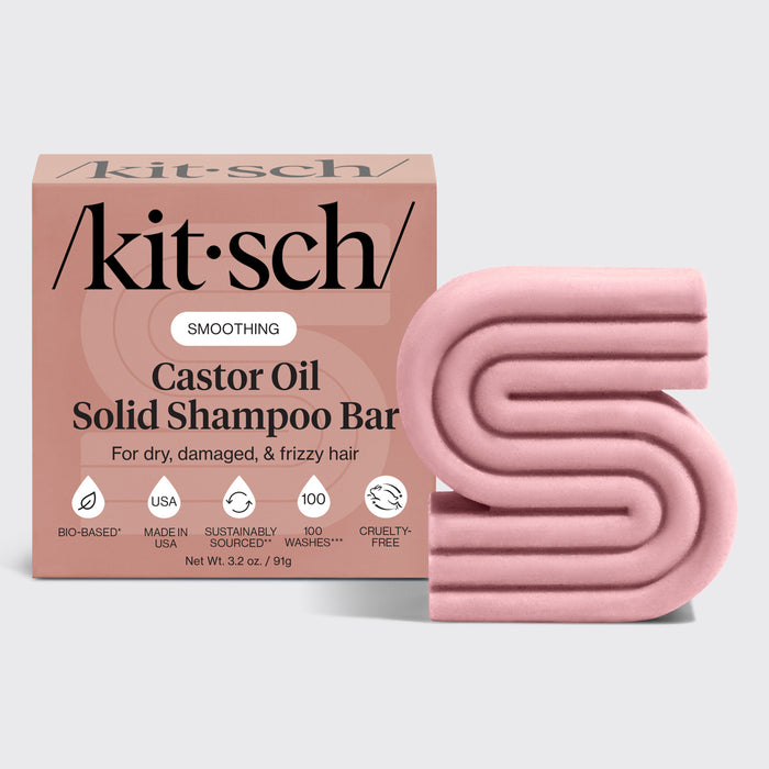 Kitsch castor oil solid shampoo bar packaging with a pink shampoo bar on a light gray background