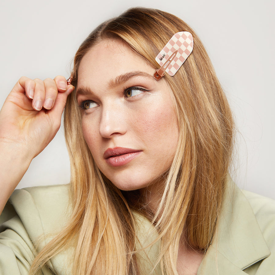 Model wearing an XL terracotta checker creaseless clip in her hair.