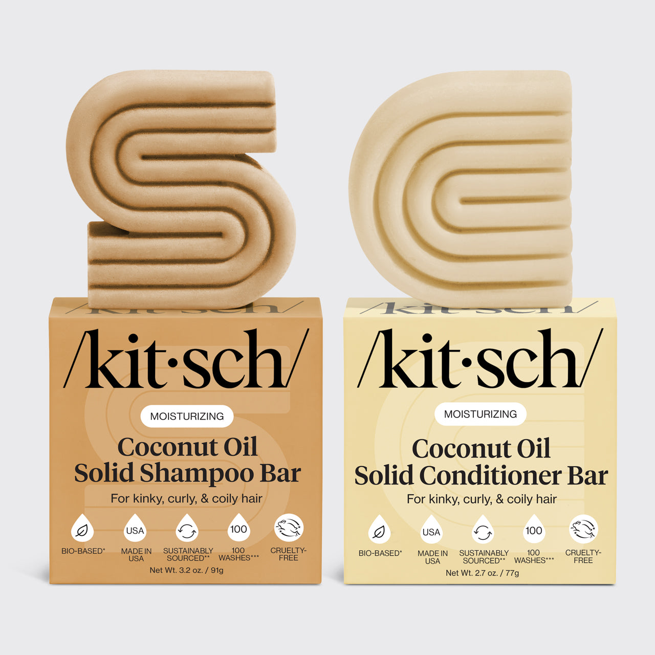 Kitsch coconut oil solid shampoo and conditioner bars on top of their packaging side by side on a light gray background.