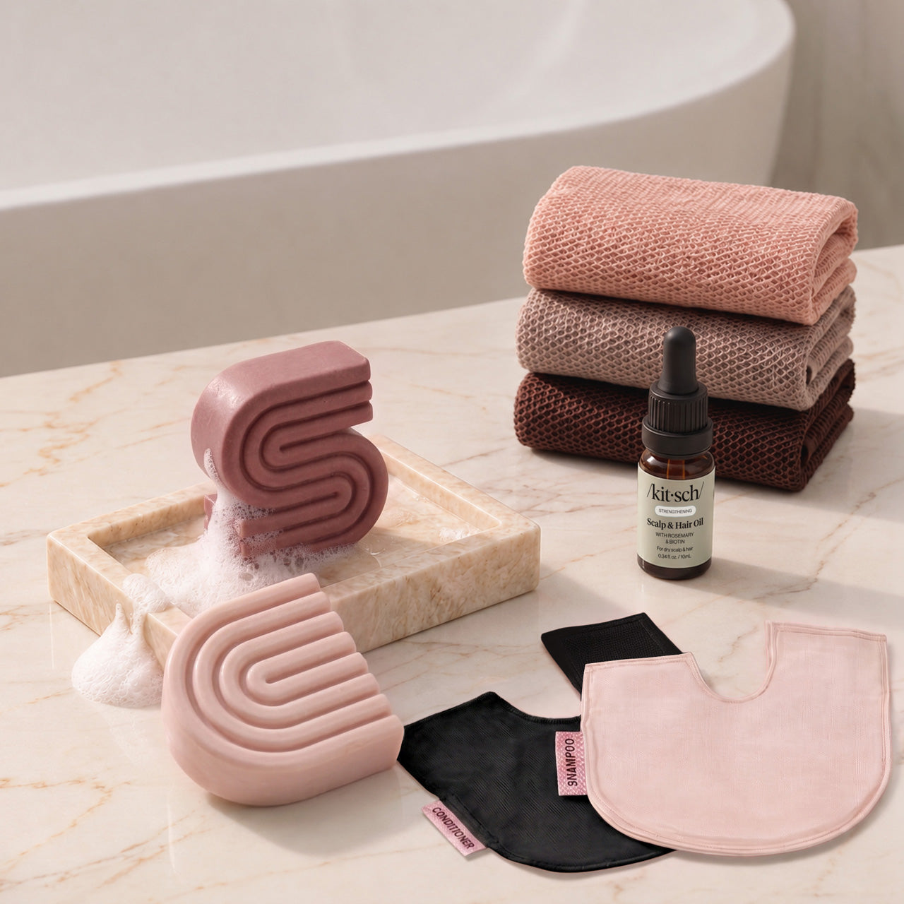 Castor Oil: Kitsch Winter Welcome Kit with Castor Oil shampoo and conditioner bars, Rosewood African Net Sponge, shampoo and conditioner bar bags, and Rosemary & Biotin Scalp & Hair Oil.