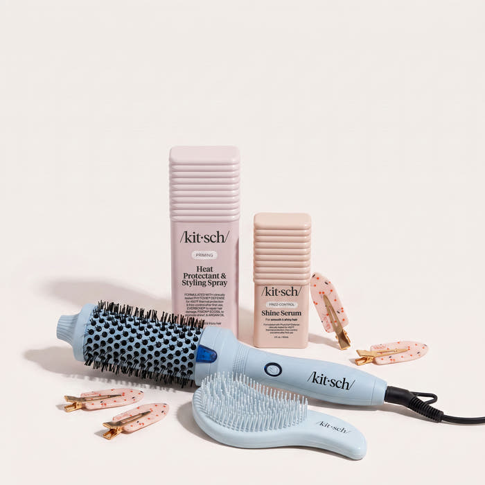 Rush Ready Bundle flat lay including Kitsch Heat Protectant & Styling Spray, Glass Hair Shine Serum, Large Volumizing Thermal Round Brush, Detangling Brush, and Cherry Print Creaseless Clips on a neutral background